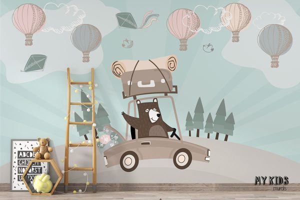 teddy bear is driving car with luggage while balloons are flying in the sky - children’s wall mural