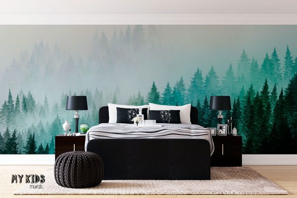 green fir forest on the hillside slope in the fog - wall mural